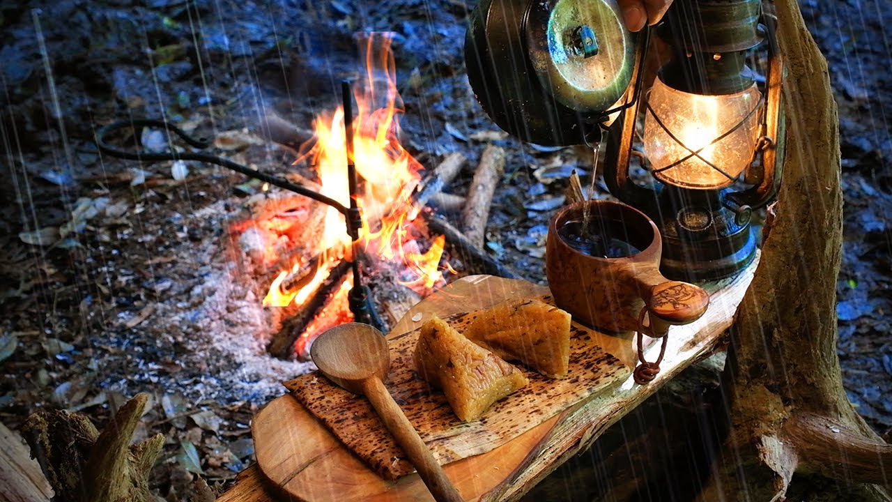 豪雨が降り注ぐ無人の森でソロキャンプ。水溜りの中で燃える焚き火（野営）